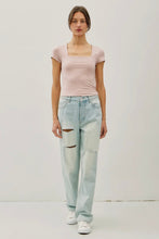 Load image into Gallery viewer, Woman wearing a pink top and light blue jeans on a white background