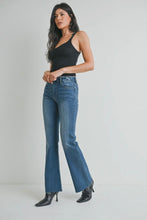 Load image into Gallery viewer, Woman wearing blue jeans and a black top on a plain background
