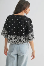 Load image into Gallery viewer, Black top with white lace details worn by a person on a plain background