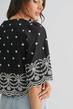 Load image into Gallery viewer, Black top with white floral patterns on a plain background