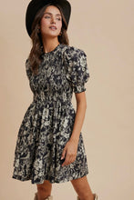 Load image into Gallery viewer, Woman wearing a black floral dress and black hat on a beige background