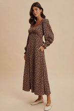 Load image into Gallery viewer, Woman wearing a floral dress against a beige background