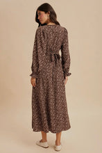 Load image into Gallery viewer, Woman wearing a floral dress against a beige background