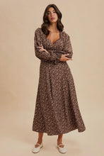 Load image into Gallery viewer, Woman wearing a floral dress against a beige background