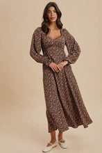 Load image into Gallery viewer, Woman wearing a brown floral dress against a beige background