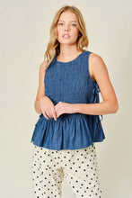 Load image into Gallery viewer, Woman wearing a blue sleeveless top with a beige background