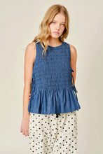 Load image into Gallery viewer, Woman wearing a blue smocked top and polka dot pants on a beige background