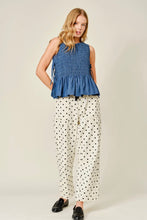 Load image into Gallery viewer, Woman wearing a blue sleeveless top and polka dot pants on a plain background