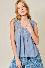 Load image into Gallery viewer, Woman wearing a blue sleeveless top with plaid shorts on a beige background