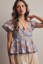 Load image into Gallery viewer, Woman wearing a floral blouse with a neutral background