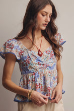 Load image into Gallery viewer, Woman wearing a floral dress with a neutral background