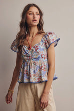 Load image into Gallery viewer, Woman wearing a floral blouse with a neutral background