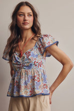 Load image into Gallery viewer, Woman wearing a floral blouse with a neutral background