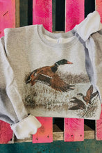 Load image into Gallery viewer, Gray sweatshirt with duck design on a pink wooden surface