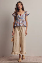 Load image into Gallery viewer, Woman wearing a floral top and beige pants against a neutral background
