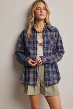 Load image into Gallery viewer, Woman wearing a blue plaid shirt over a white top and green shorts against a plain background