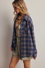 Load image into Gallery viewer, Woman wearing a blue plaid shirt over a beige top and green shorts on a plain background