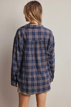 Load image into Gallery viewer, Person wearing a blue plaid shirt against a plain background
