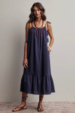 Load image into Gallery viewer, Woman wearing a navy blue dress with red necklace against a plain background
