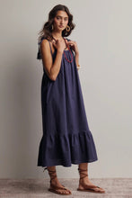Load image into Gallery viewer, Woman wearing a dark blue dress with a plain background