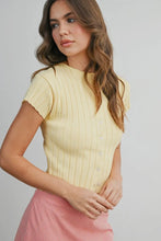 Load image into Gallery viewer, Woman wearing a yellow ribbed top and pink skirt against a gray background