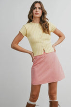 Load image into Gallery viewer, Woman wearing a yellow top and pink skirt on a plain background