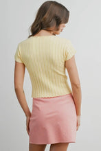 Load image into Gallery viewer, Woman wearing a yellow ribbed top and pink skirt on a plain background