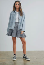 Load image into Gallery viewer, Woman wearing a denim jacket, white shirt, checkered skirt, and black sneakers on a plain background
