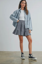 Load image into Gallery viewer, Woman wearing a denim jacket, white shirt, checkered skirt, and black sneakers on a plain background