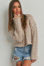 Load image into Gallery viewer, Woman wearing a beige cable knit sweater and denim shorts against a plain background