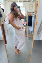 Load image into Gallery viewer, Woman taking a mirror selfie wearing a striped dress in a clothing store.