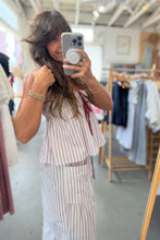 Load image into Gallery viewer, Woman taking a mirror selfie wearing a striped dress in a clothing store.