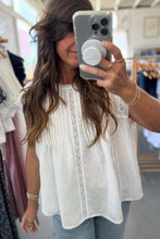 Load image into Gallery viewer, Woman taking a mirror selfie wearing a white blouse in a clothing store.