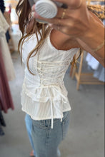 Load image into Gallery viewer, Person wearing a white lace top and blue jeans taking a mirror selfie in a store.