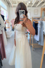 Load image into Gallery viewer, Woman taking a mirror selfie wearing a white dress in a clothing store.