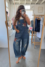 Load image into Gallery viewer, Person wearing denim overalls with star patterns in a clothing store.
