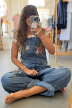 Load image into Gallery viewer, Person wearing a denim outfit with star patterns, sitting on the floor in a clothing store.