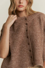Load image into Gallery viewer, Woman wearing a brown knitted cardigan with buttons on a plain background