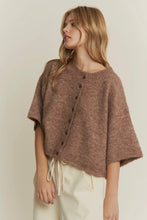 Load image into Gallery viewer, Woman wearing a brown knitted poncho against a plain background