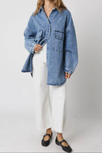 Load image into Gallery viewer, Woman wearing a blue denim shirt and white pants on a plain background