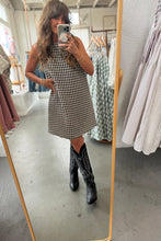 Load image into Gallery viewer, Person wearing a checkered dress and black boots in a clothing store.