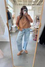 Load image into Gallery viewer, Person taking a mirror selfie wearing a brown top and light blue jeans in a store.