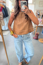 Load image into Gallery viewer, Person wearing a brown sleeveless top and light blue jeans in a store setting.