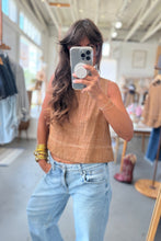 Load image into Gallery viewer, Woman taking a mirror selfie wearing a brown top and light blue jeans in a clothing store.