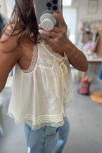 Load image into Gallery viewer, Person wearing a light-colored lace-trimmed top and jeans, taking a mirror selfie.