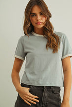 Load image into Gallery viewer, Woman wearing a light gray t-shirt with white trim against a plain background