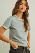Load image into Gallery viewer, Woman wearing a light gray t-shirt with white trim on a plain background