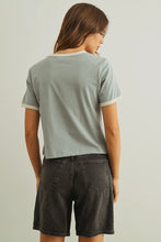 Load image into Gallery viewer, Woman wearing a light gray t-shirt and black shorts against a plain background