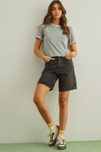 Load image into Gallery viewer, Woman wearing a light gray t-shirt, black denim shorts, and sneakers with a white background
