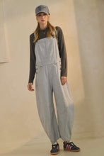 Load image into Gallery viewer, Person wearing a gray checkered overalls with a plain background